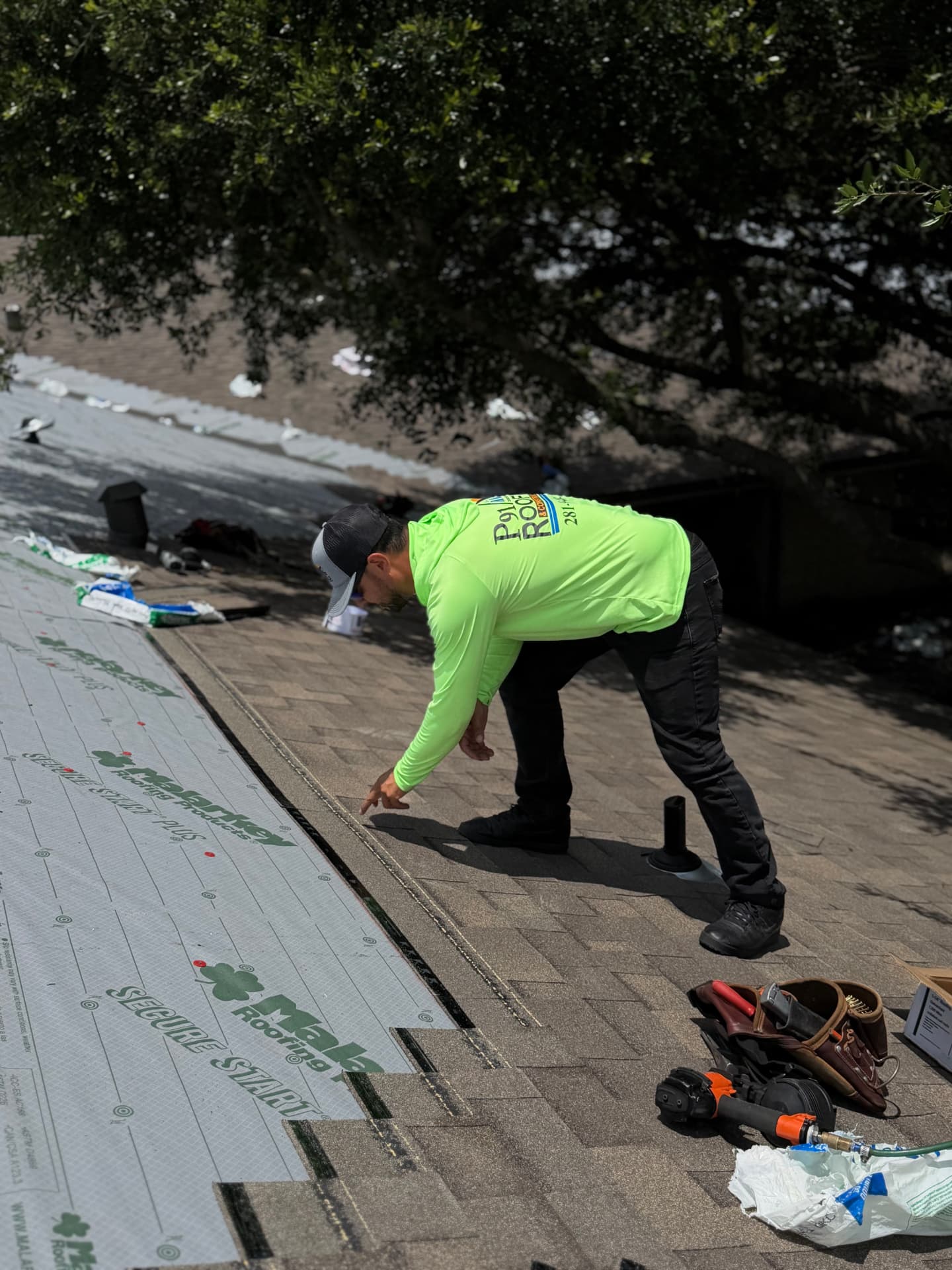 P91 technician inspecting shingle courses and underlayment