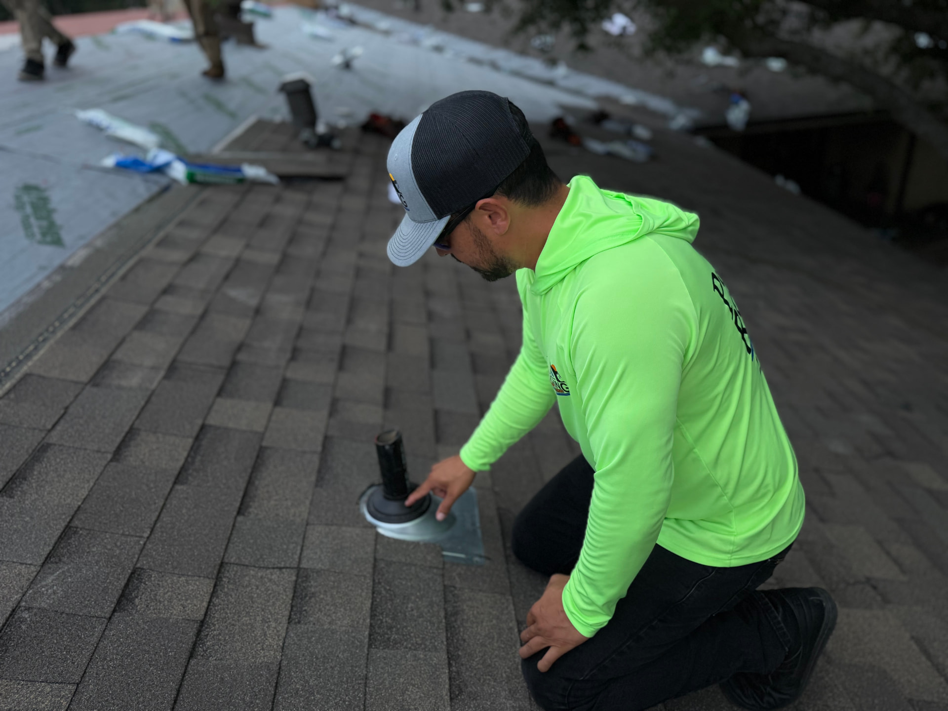P91 technician setting a new pipe boot flashing, sealed 100%